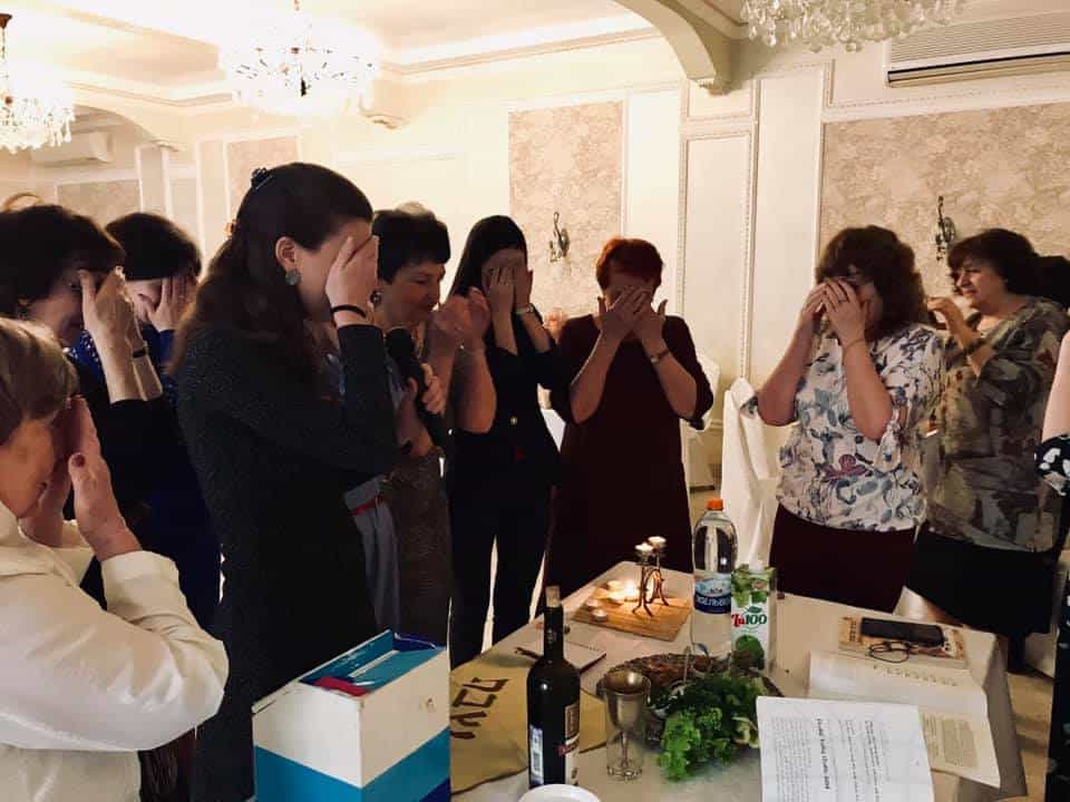 Anna leading the Jewish community of Lipetsk, Russia, by ushering in Shabbat and Passover with candle lighting.