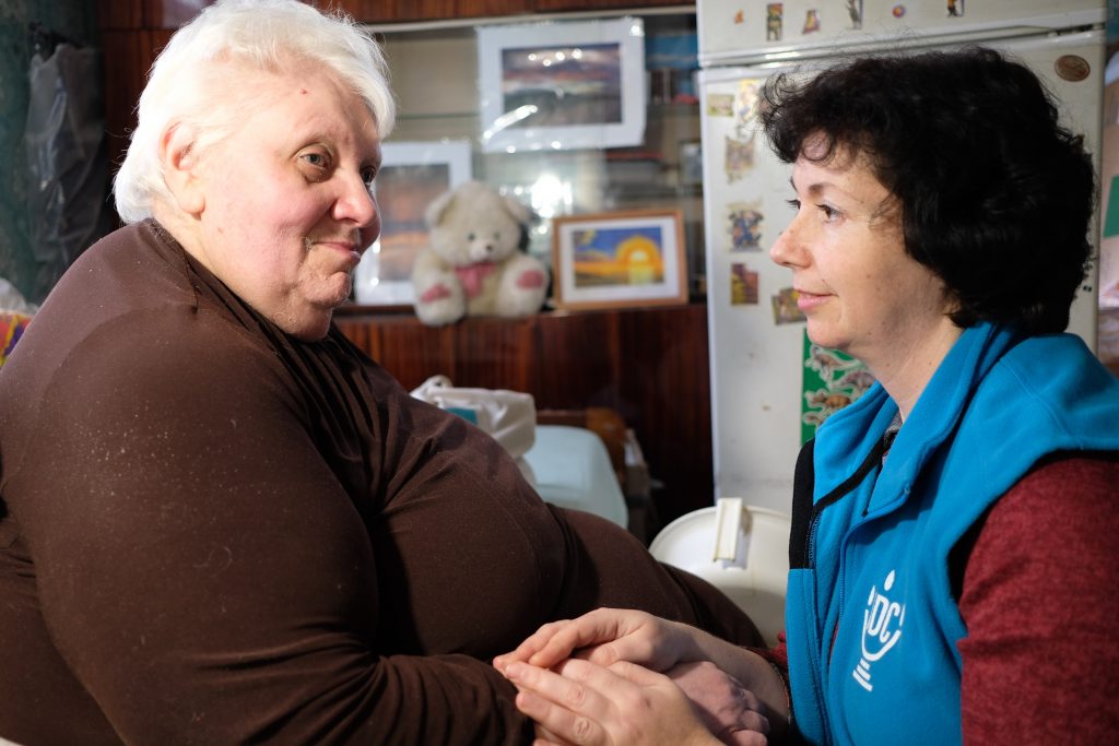 Liudmila Starikovich with her JDC homecare worker. Liudmila has been homebound for 10 years; she describes her homecare worker as “the sunshine in my window” and her “eyes, legs, and ears.”