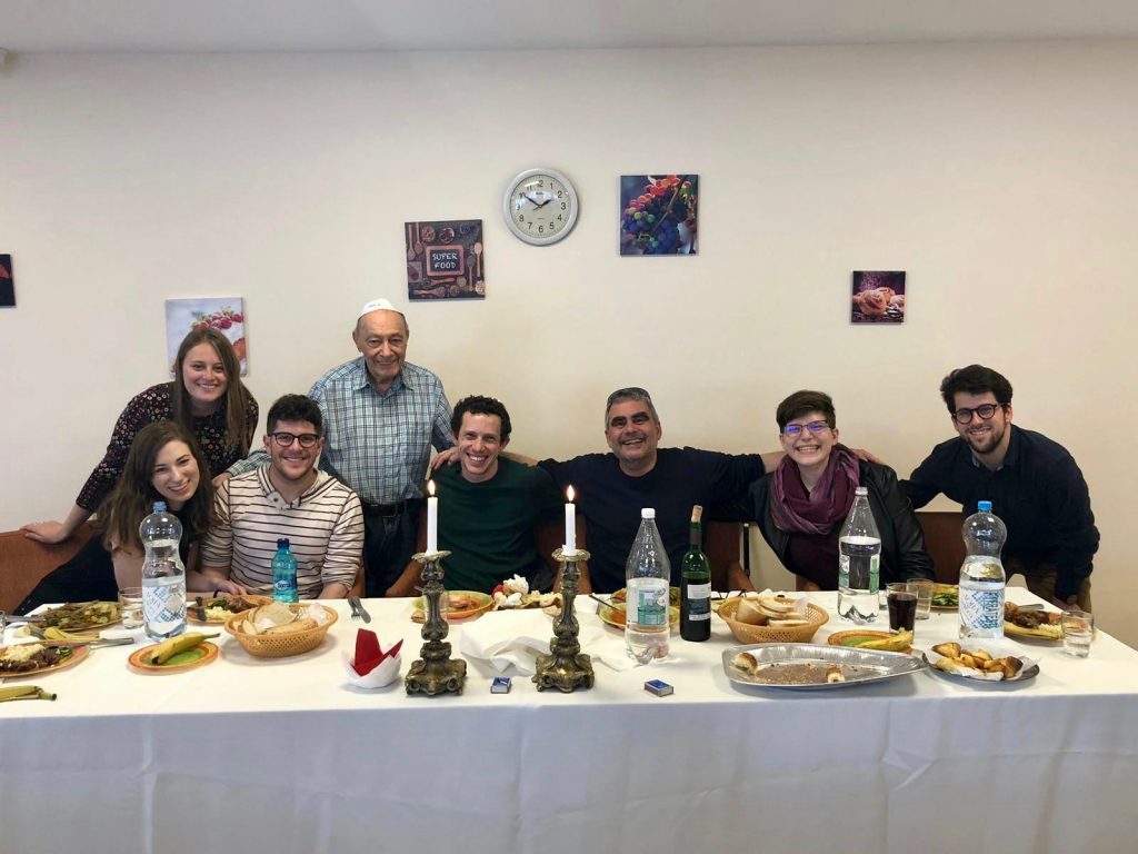 Anna and JDC-Weitzman Fellows gather at a senior center in Romania to welcome Shabbat together with a festive meal.