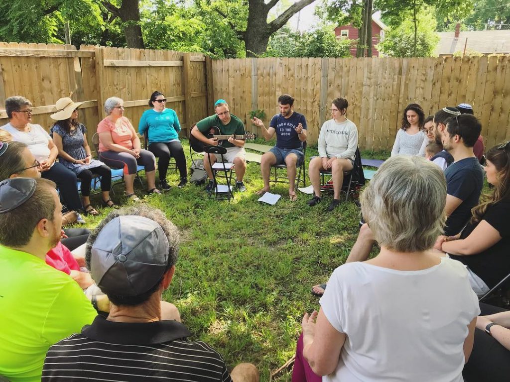 Rabbi Alex Braver (center) leads a song circle, before the coronavirus Pandemic.