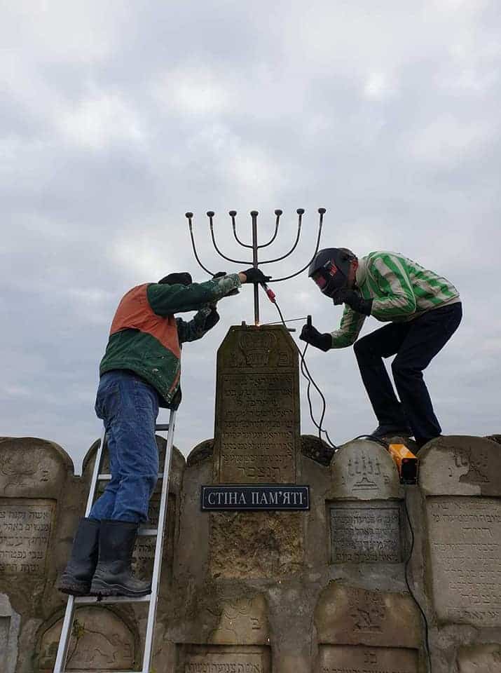 Sasha and his volunteers turned 100 reclaimed tombstones into a memorial — a "wall of memory" for Dobromyl