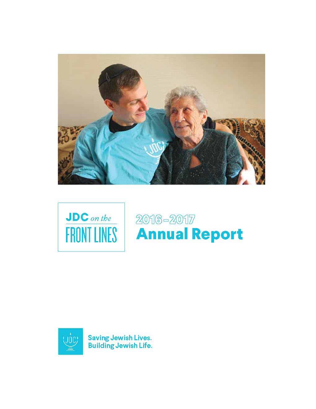 JDC's Annual Report 2017 in which a JDC homecare worker in the former Soviet Union embraces an elderly client on her couch.