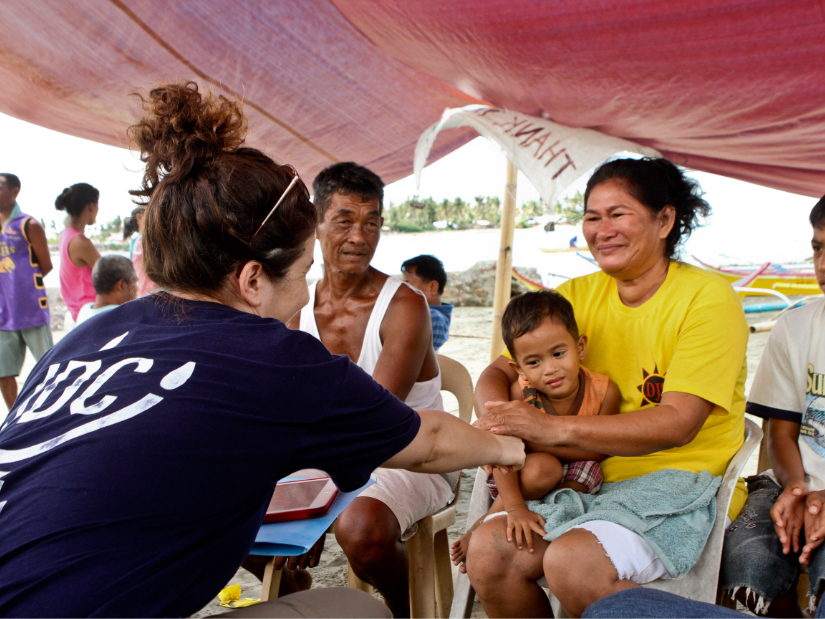 A JDC humanitarian aid worker in the Phillipines meeting with family in the aftermath of Typhoon Haiyan.